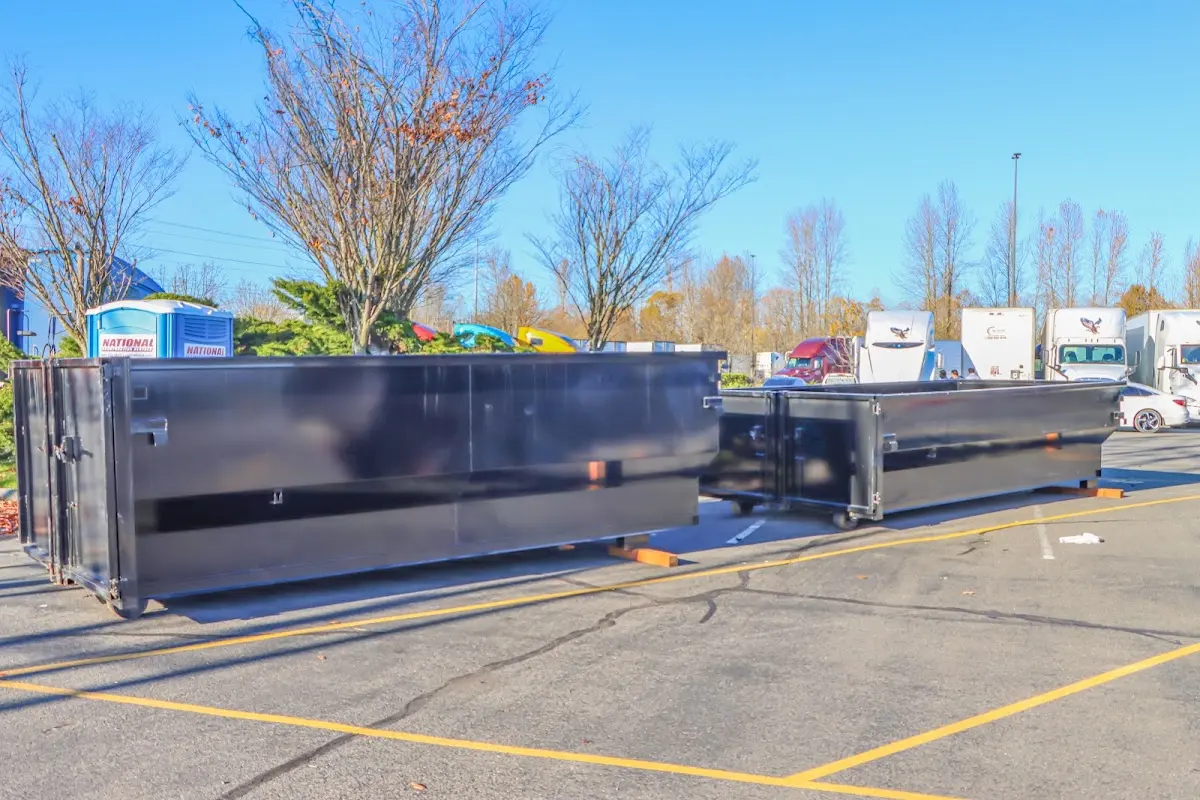 Professional dumpster rental service with roll-off container on residential driveway in Upper Merion